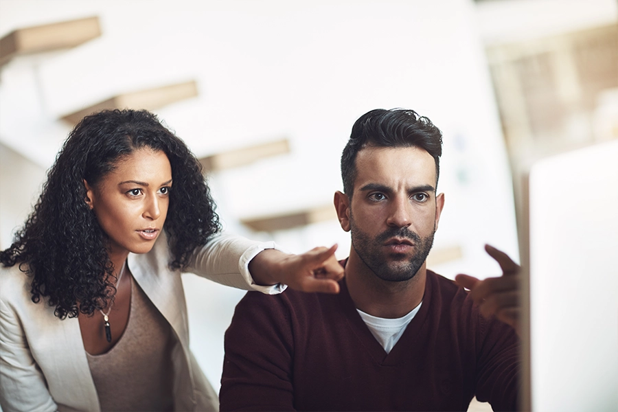 Man and woman point to screen detecting something